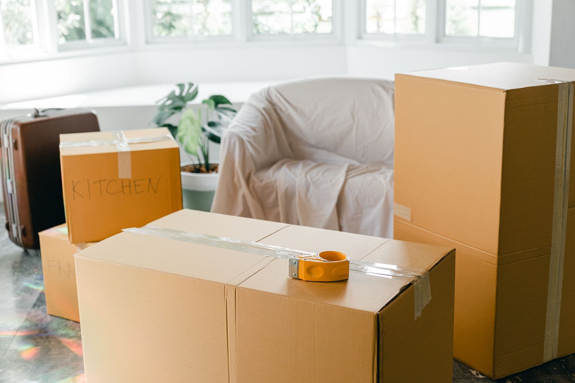 Cardboard moving boxes stacked in an empty apartment